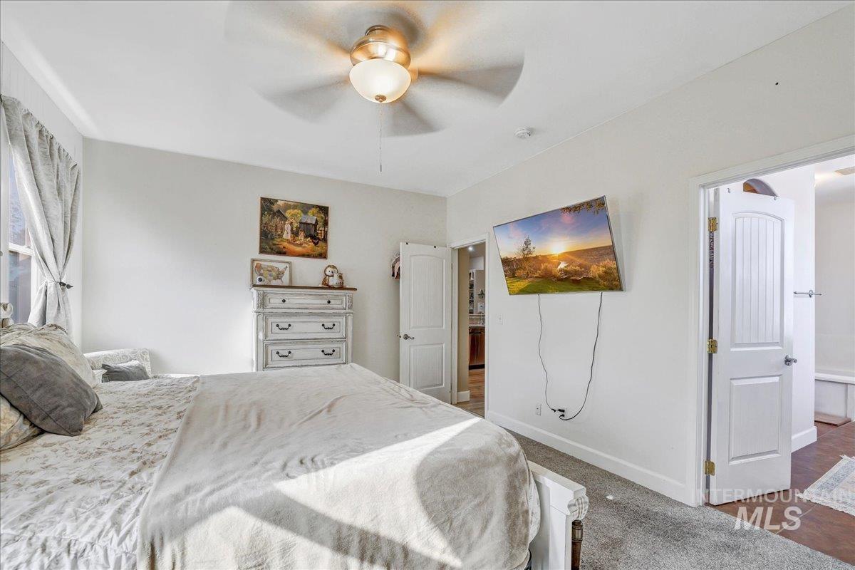 Bedroom with ceiling fan and baseboards