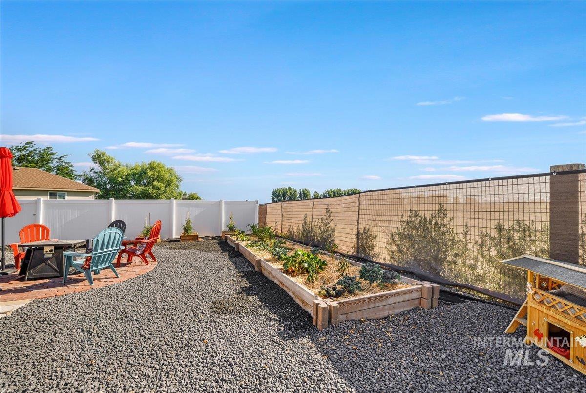 Fenced backyard with a garden and a patio