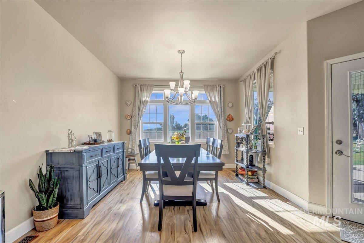 Dining area featuring a chandelier and light wood-type flooring