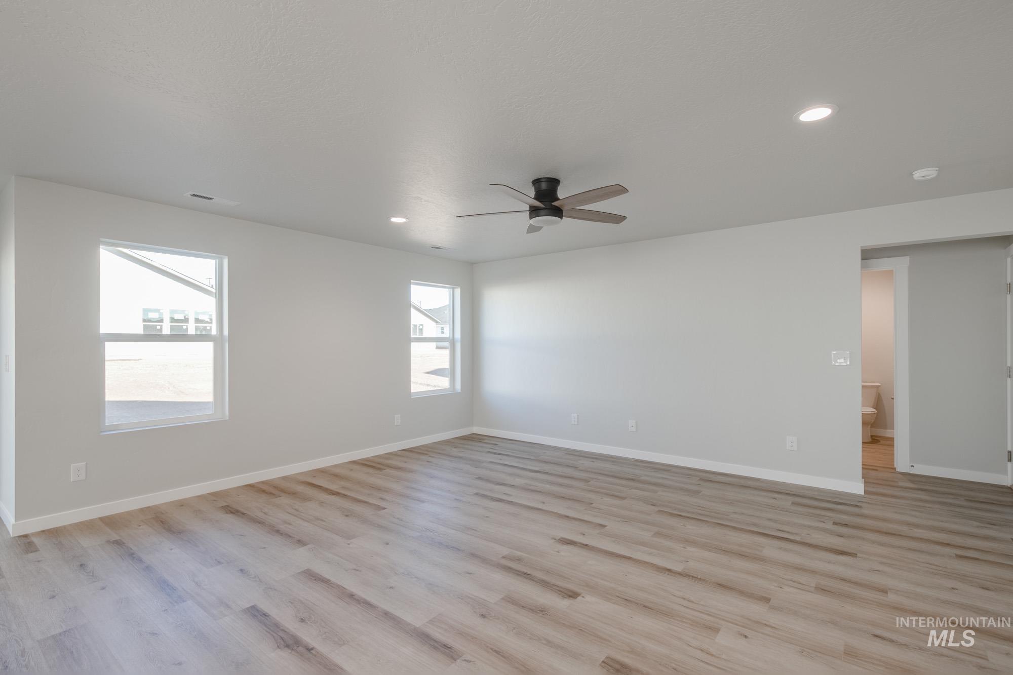 Unfurnished room with light wood finished floors, recessed lighting, and a ceiling fan
