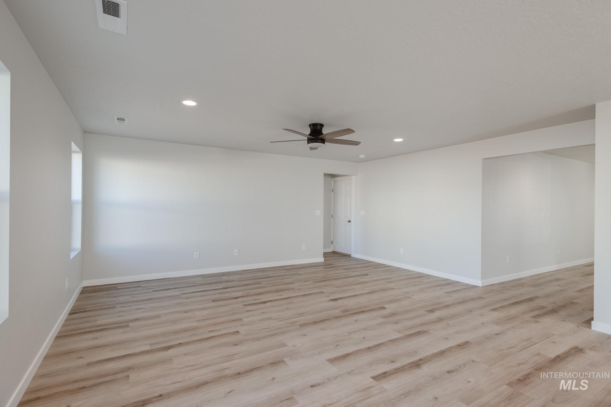 Unfurnished room with light wood finished floors, recessed lighting, and ceiling fan