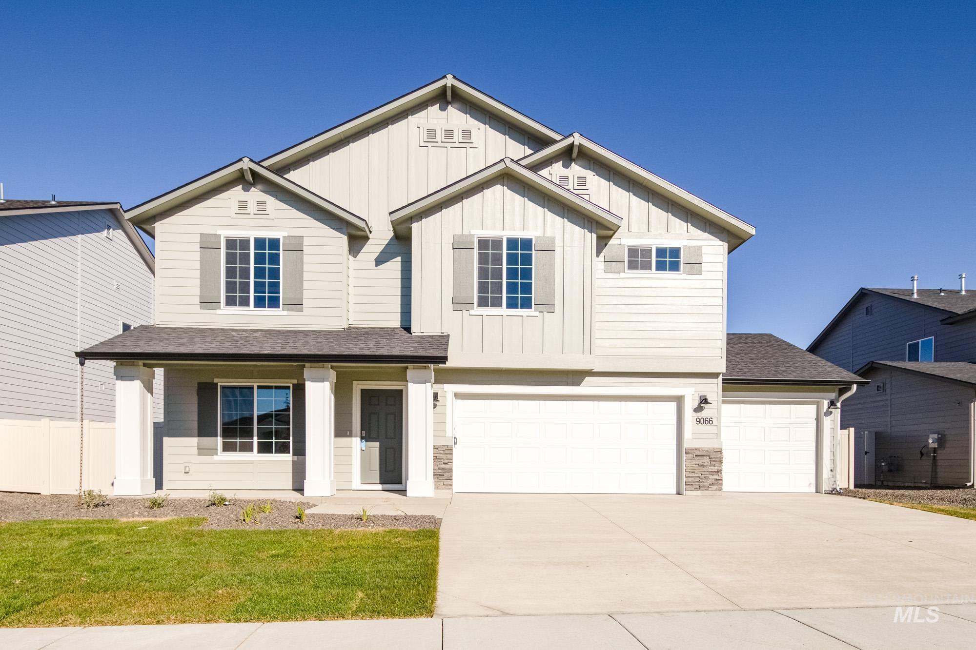 View of front of property with a shingled roof, a porch, board and batten siding, concrete driveway, and stone siding