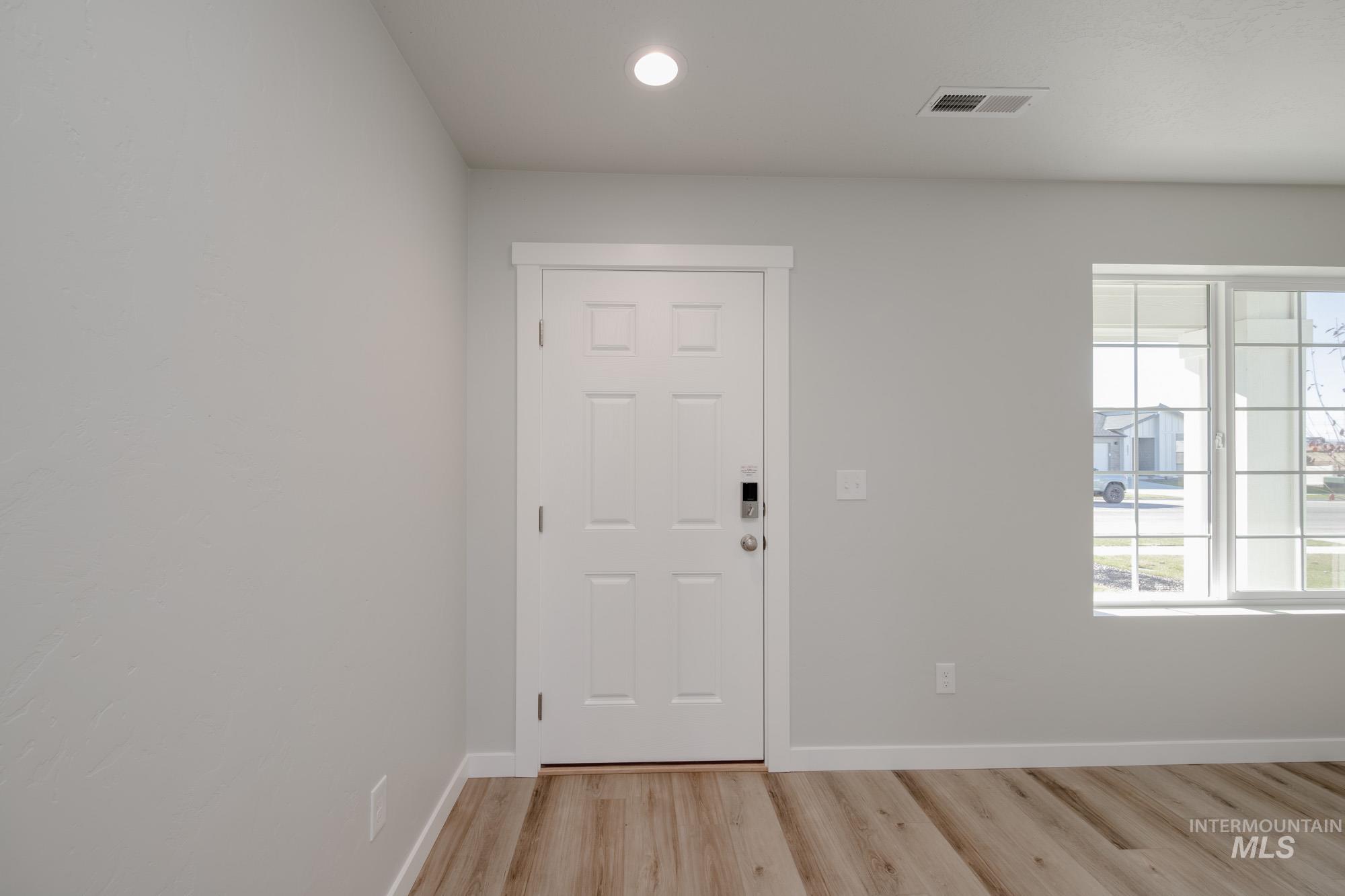 Entryway featuring light wood-type flooring and recessed lighting