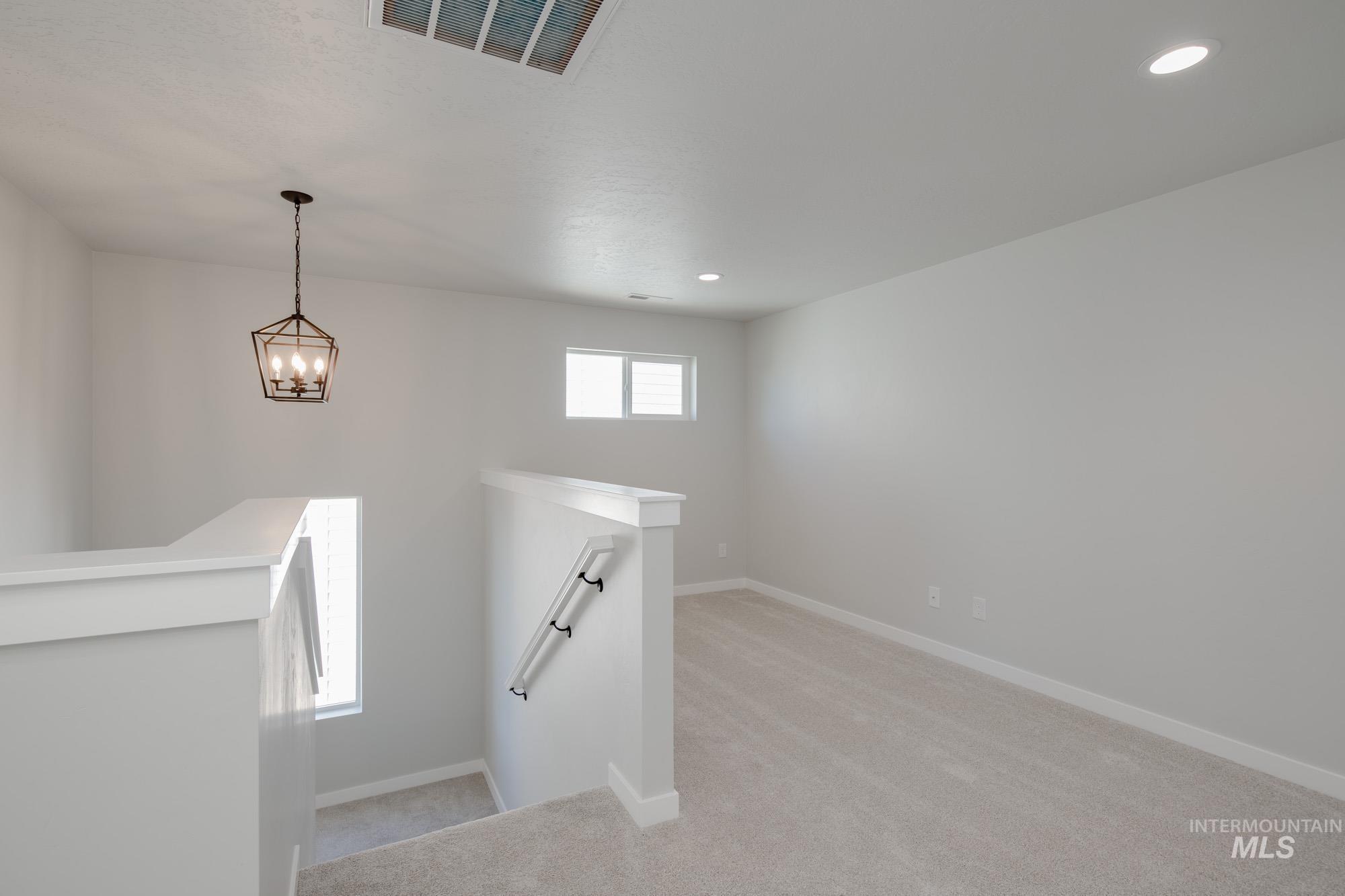 Staircase featuring carpet, recessed lighting, and a chandelier