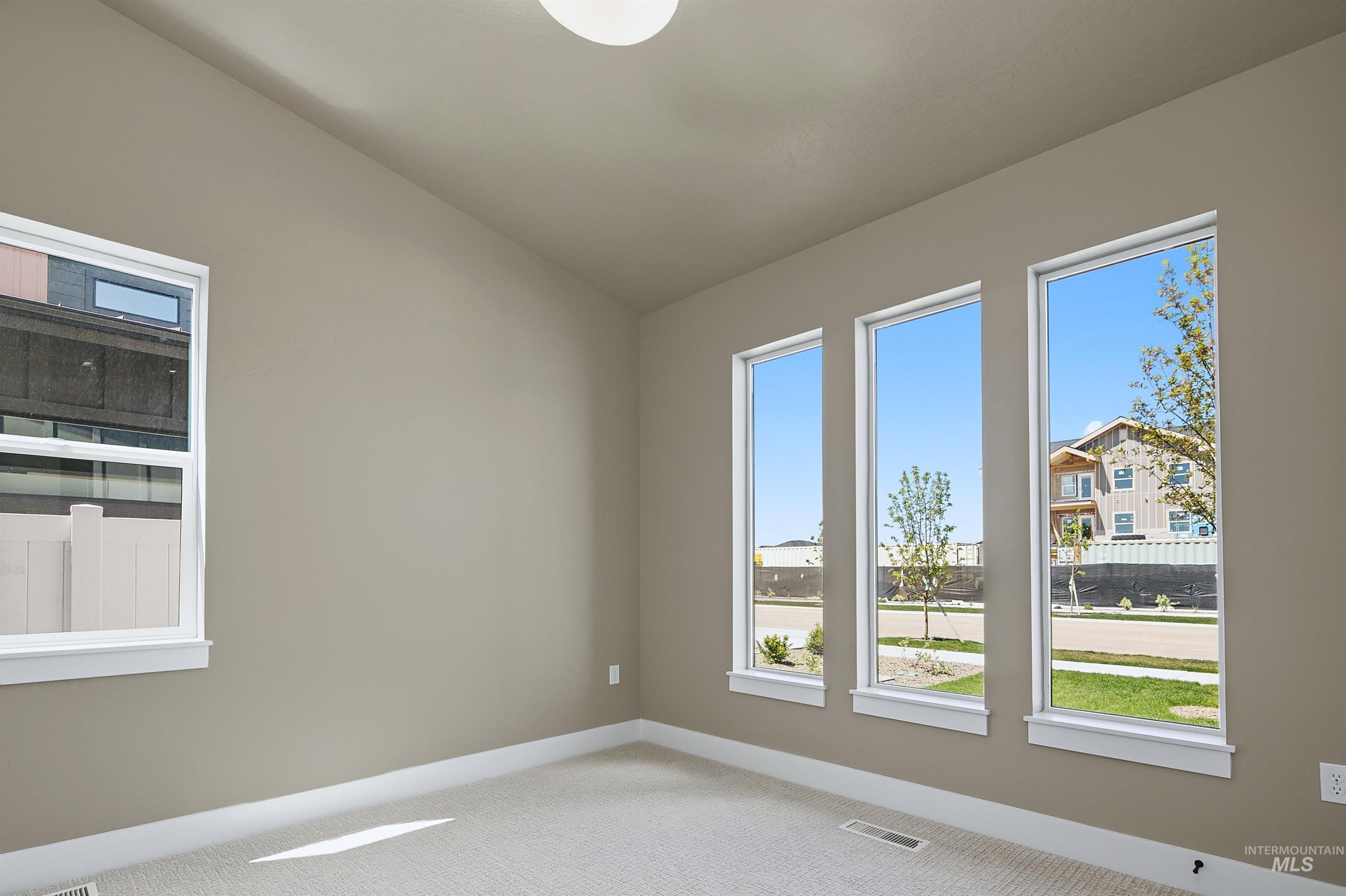 Neutral-toned walls complement a light-colored carpeted floor