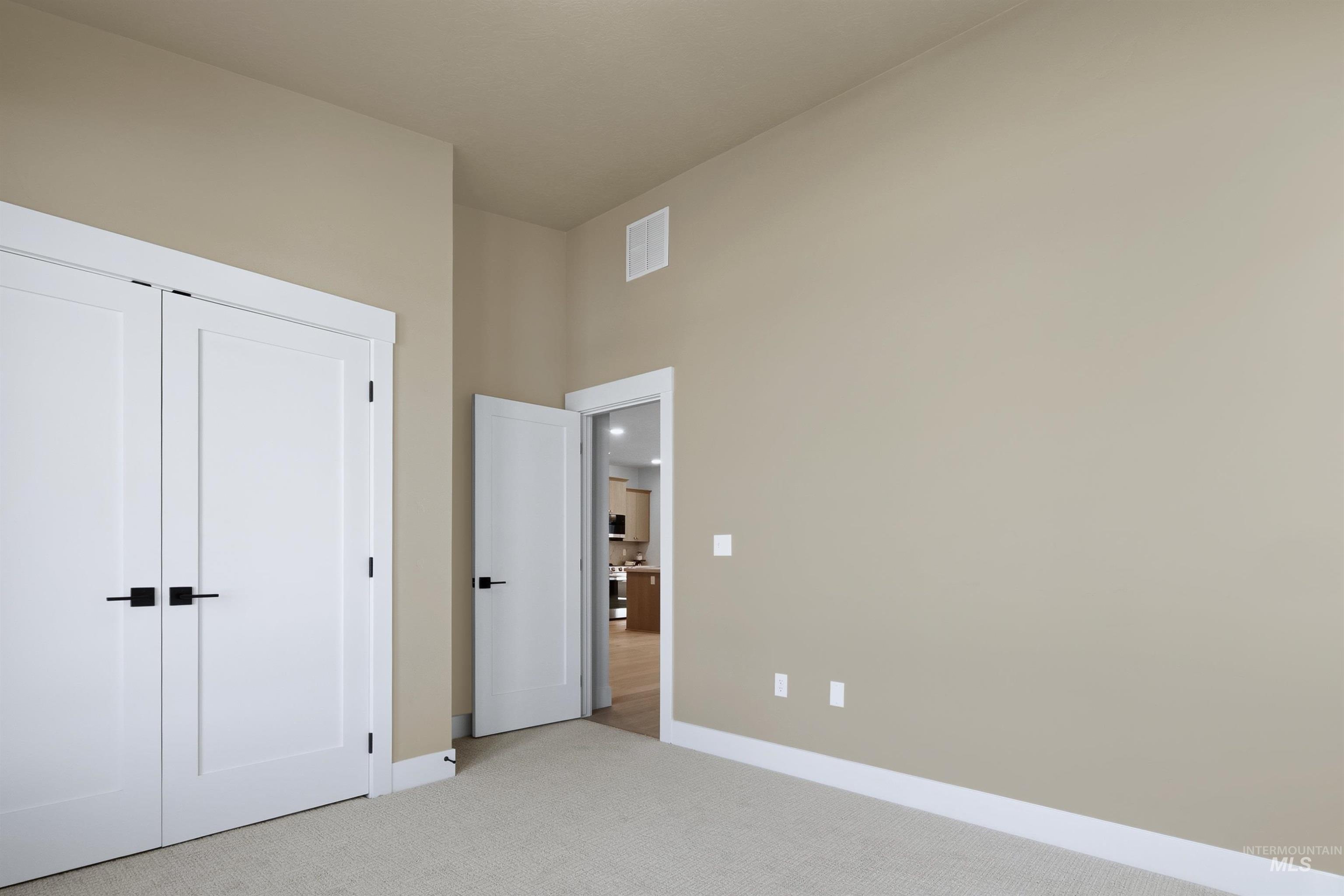Neutral-toned walls complementing light carpet flooring