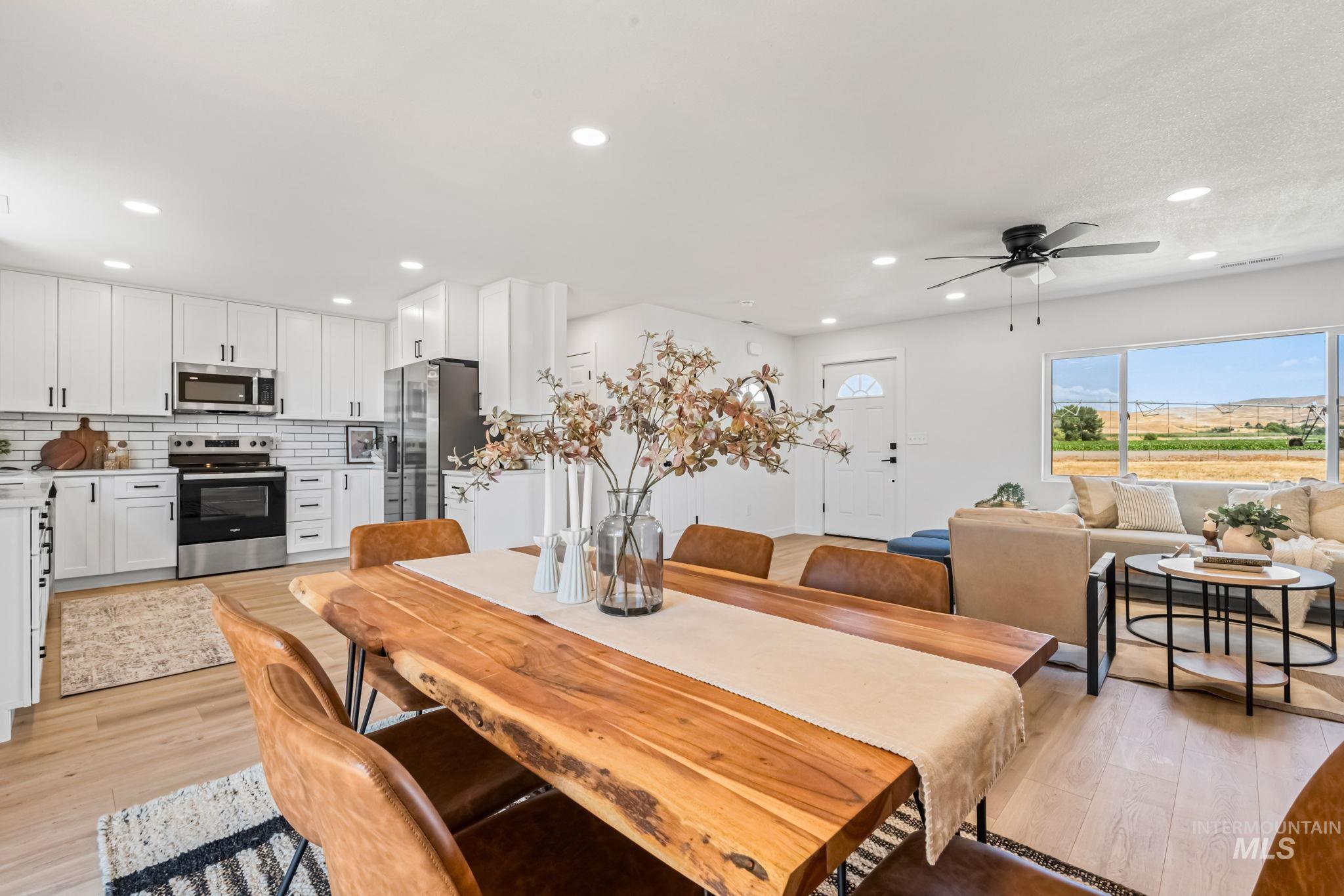 Dining room with light wood finished floors, ceiling fan, and recessed lighting
