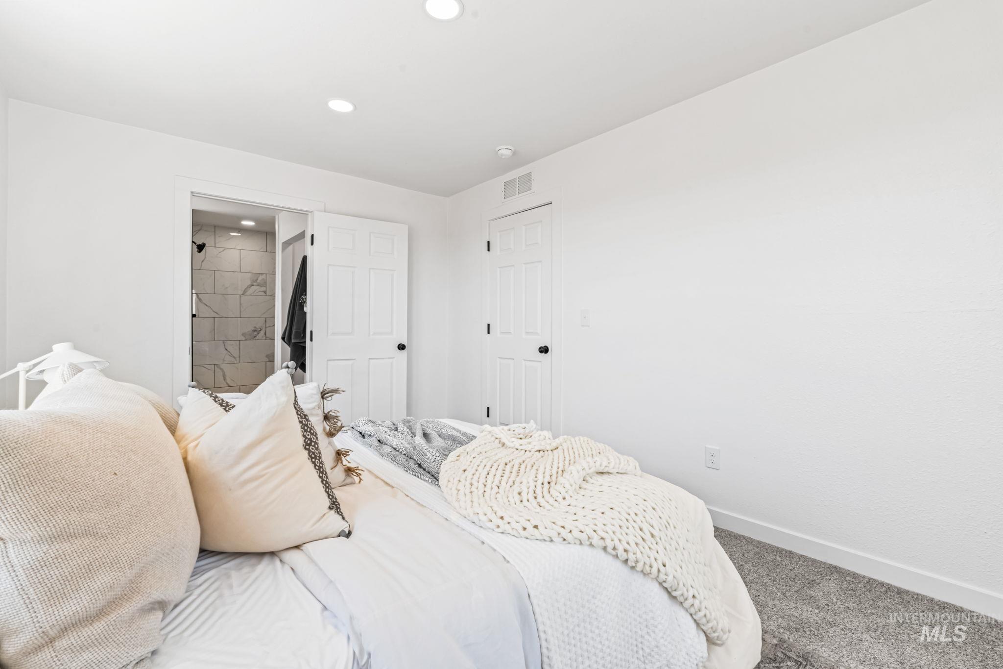 Carpeted bedroom featuring baseboards and recessed lighting