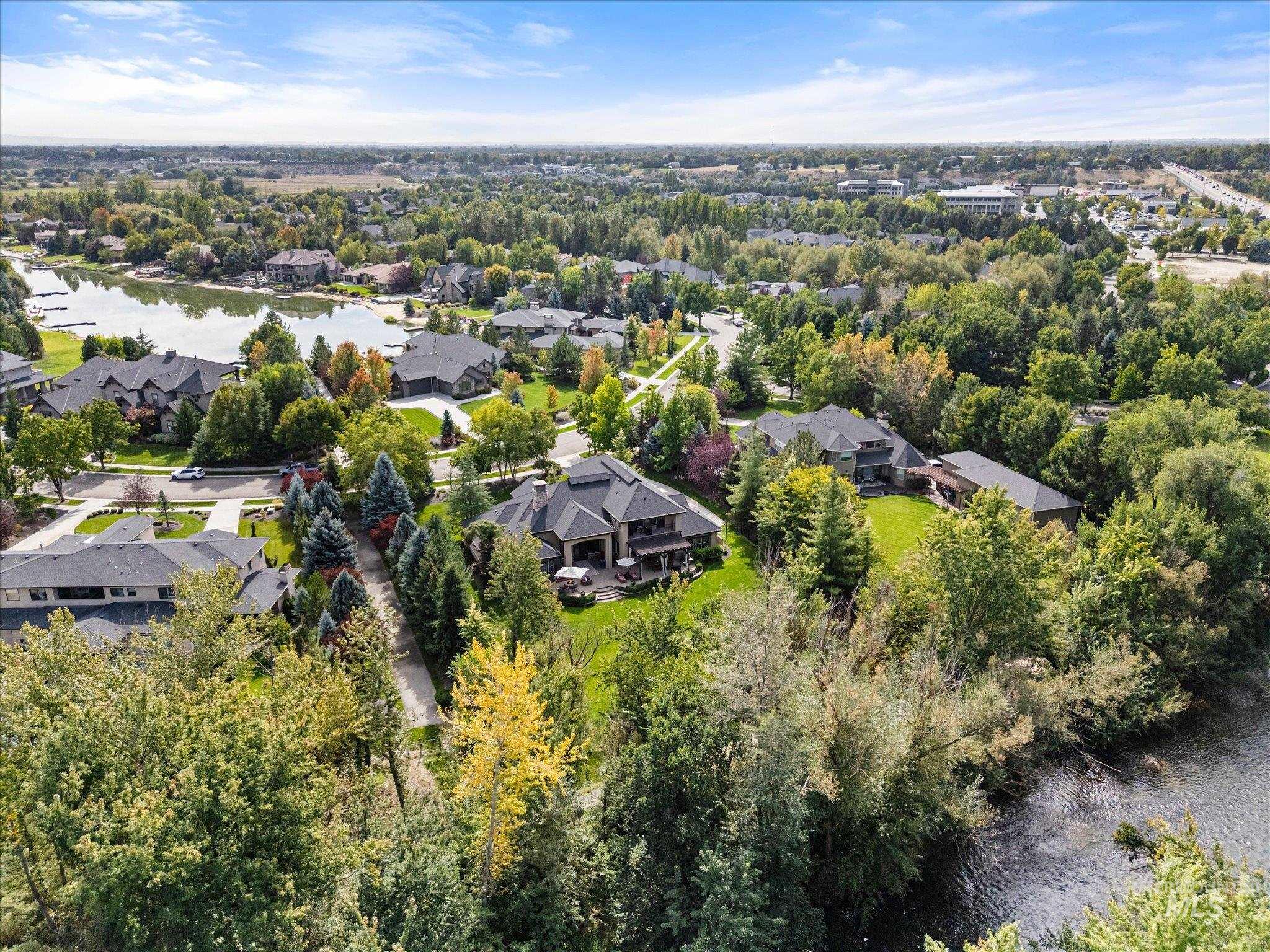 View of property location featuring a large body of water and nearby suburban area
