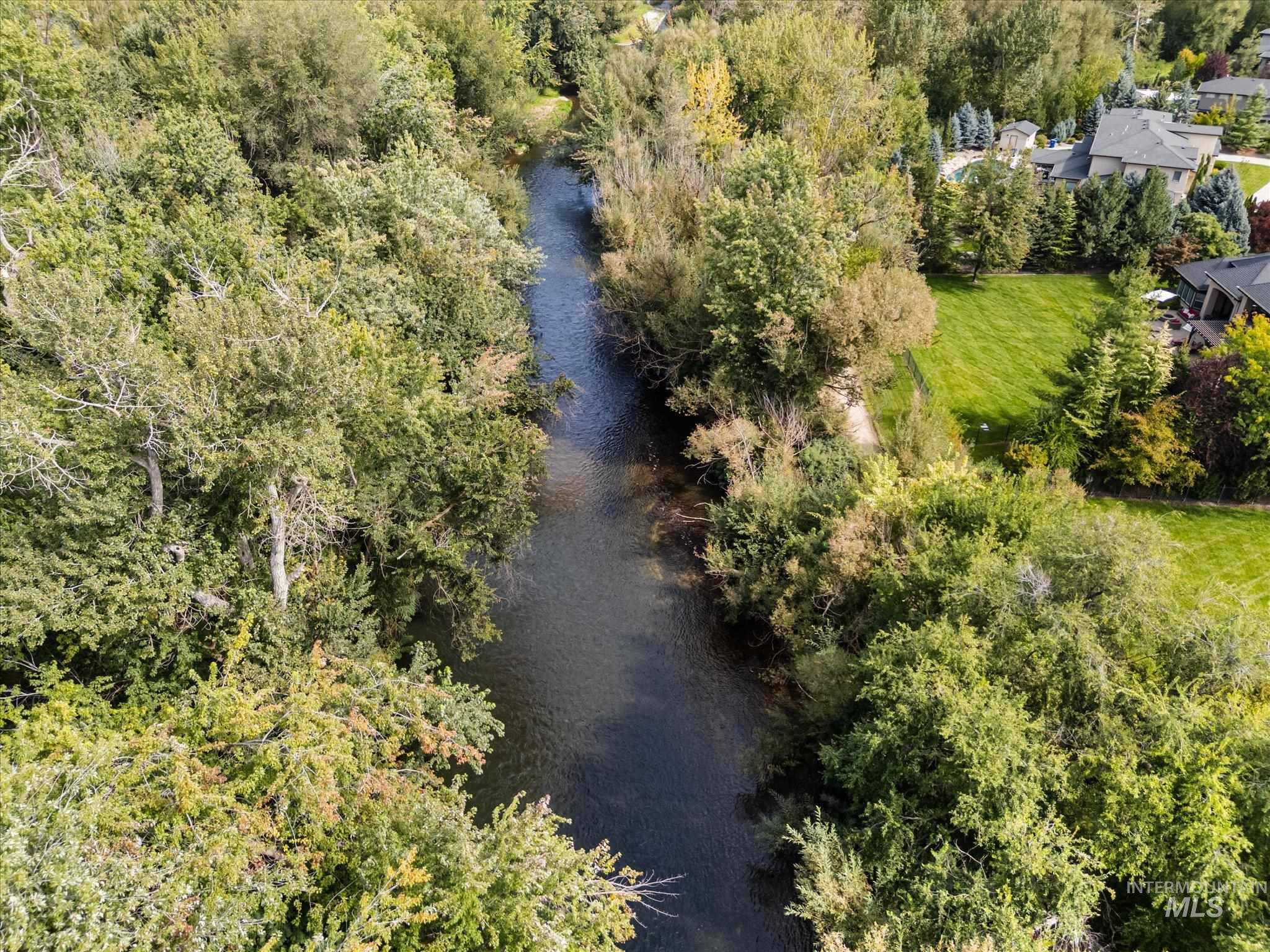 Aerial view of a large body of water and a tree filled landscape