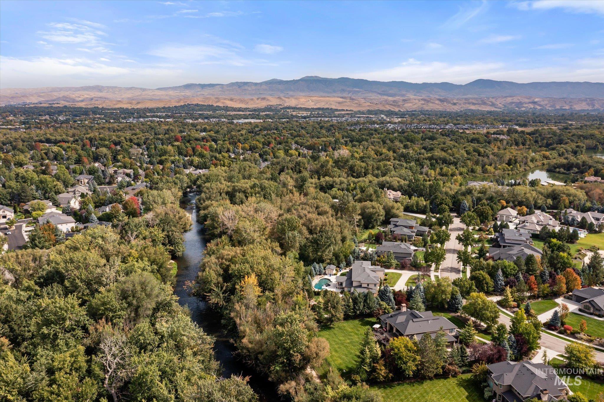 Aerial perspective of suburban area with a water and mountain view