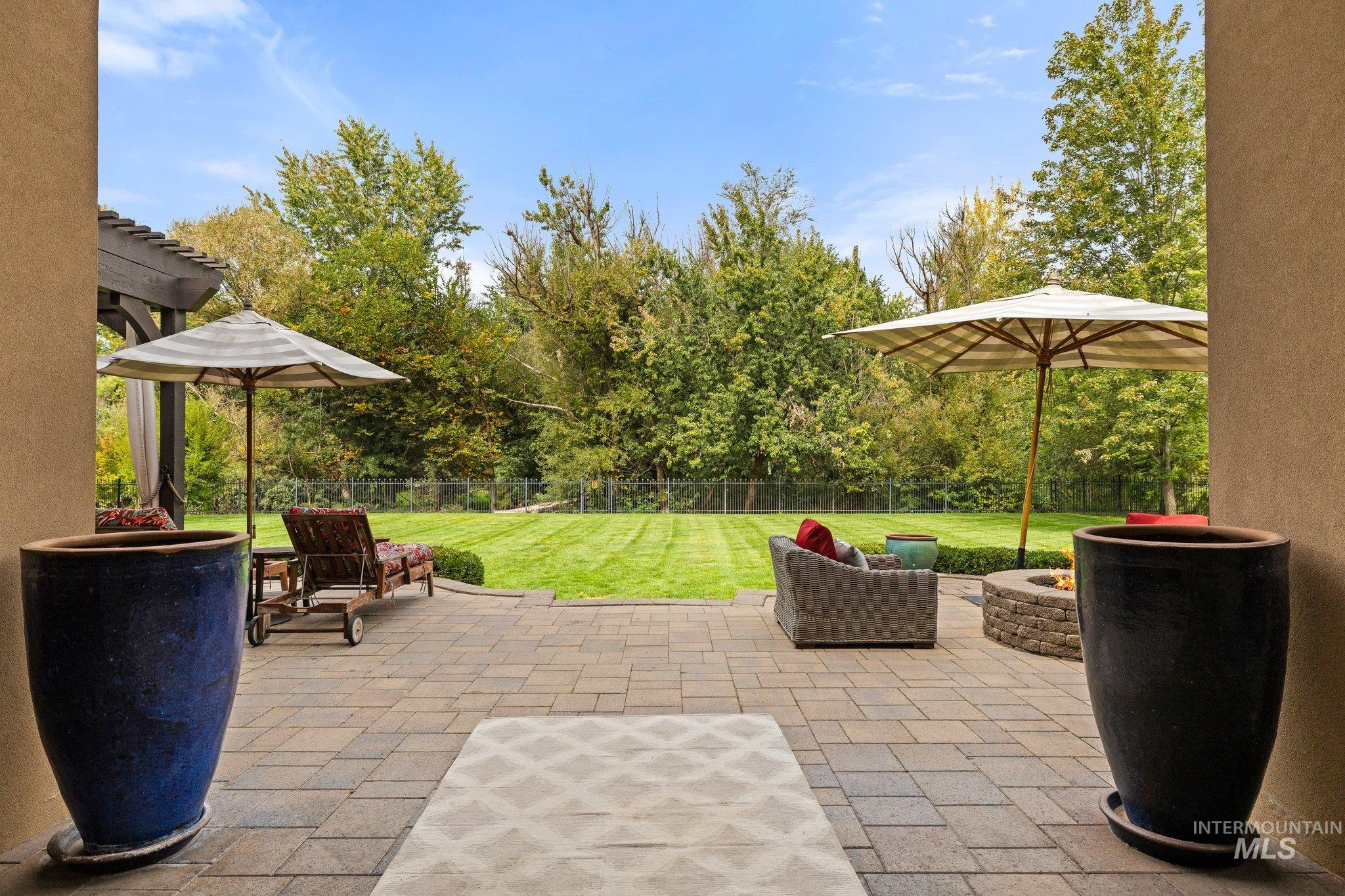 Fenced backyard with a patio and a pergola