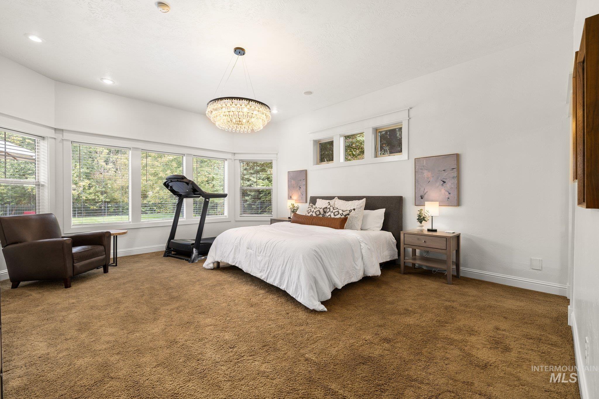 Bedroom featuring carpet and a chandelier