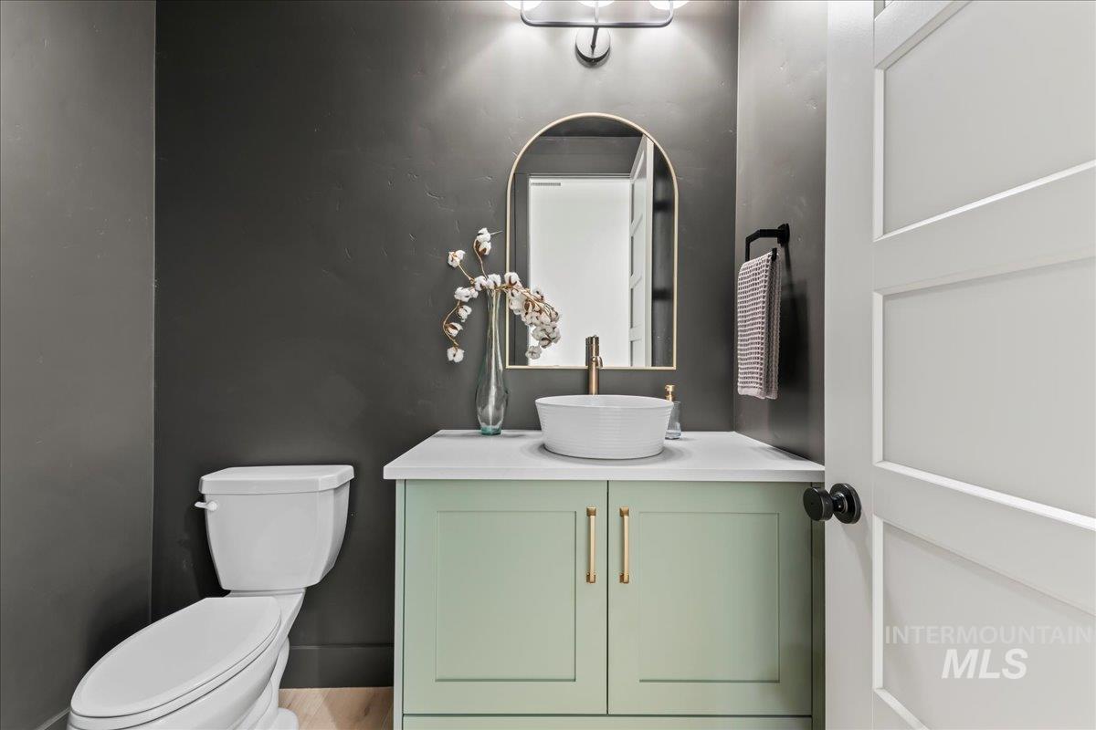 Half bath featuring vanity and toilet