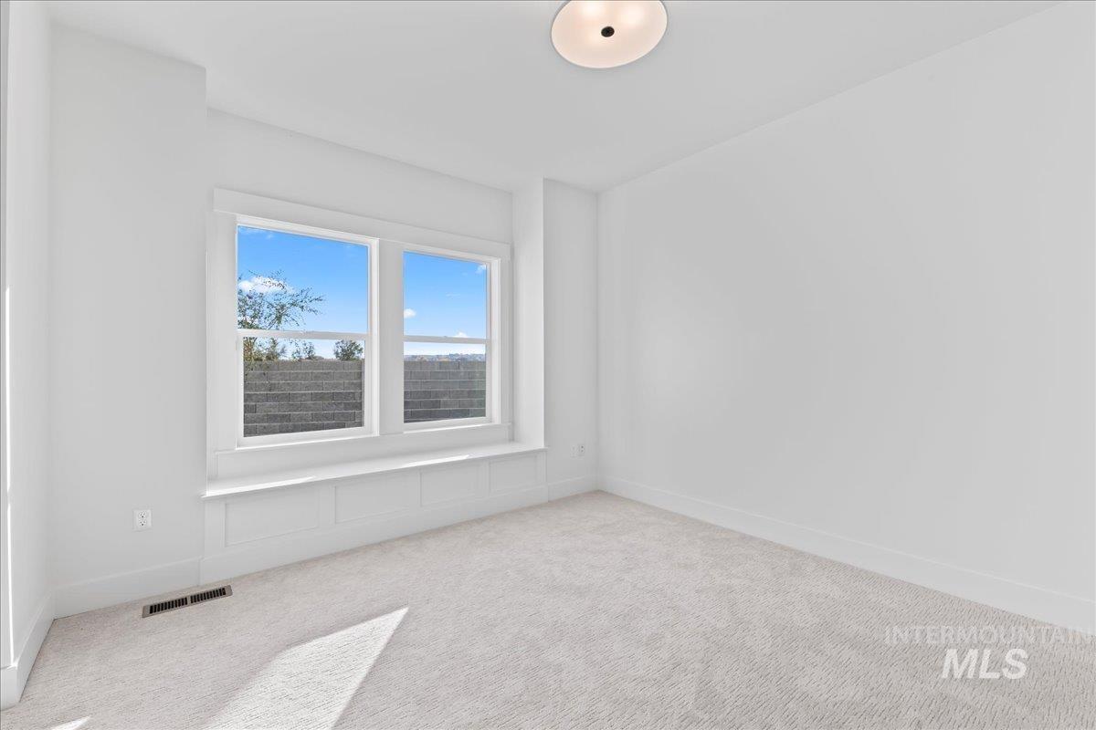 Spare room with carpet floors and baseboards