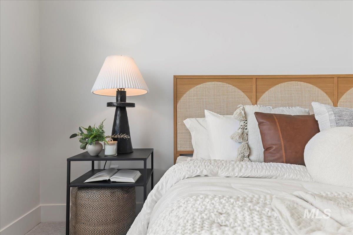 Carpeted bedroom featuring baseboards