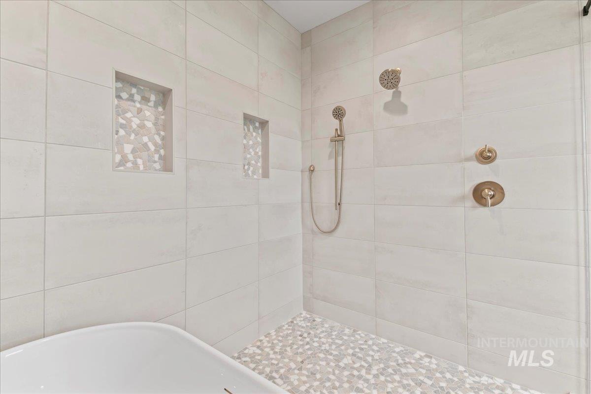Full bathroom with a tile shower and a soaking tub