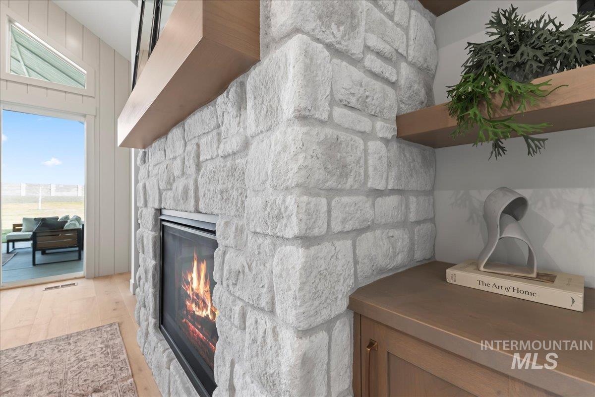 Detailed view of a fireplace and wood finished floors