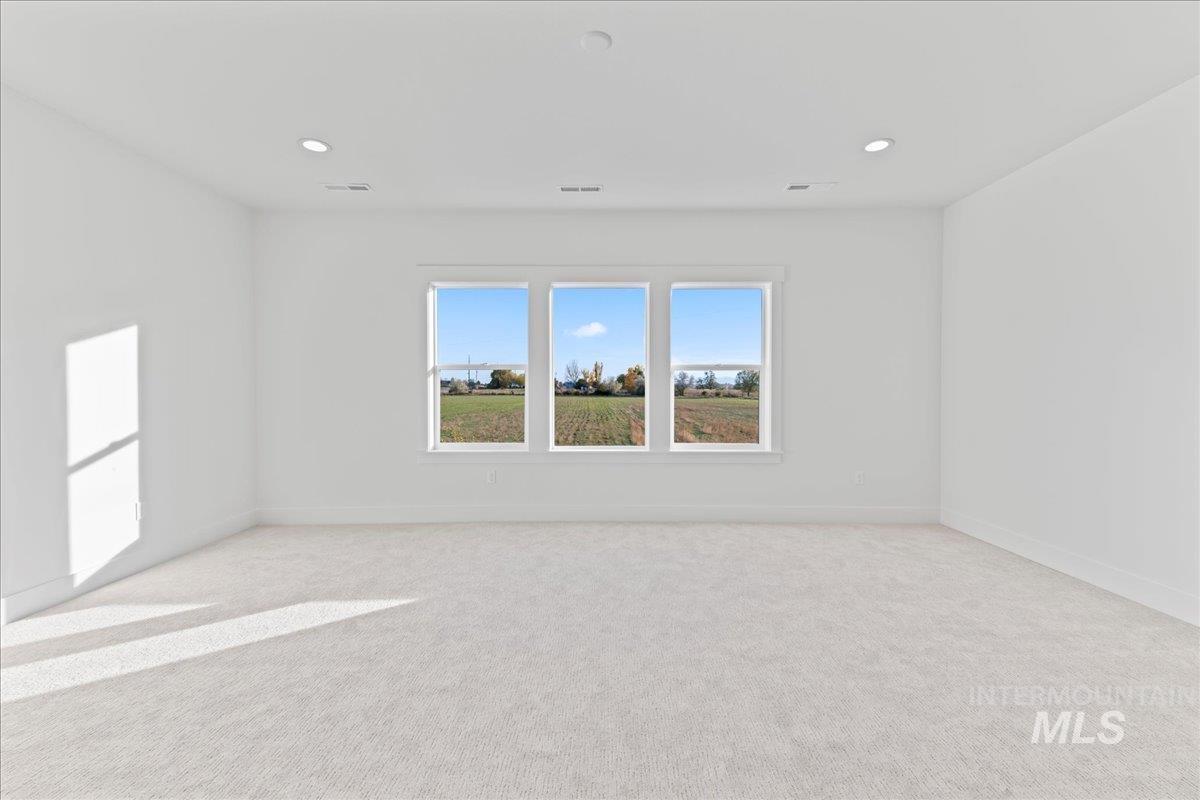 Unfurnished room with light carpet and recessed lighting