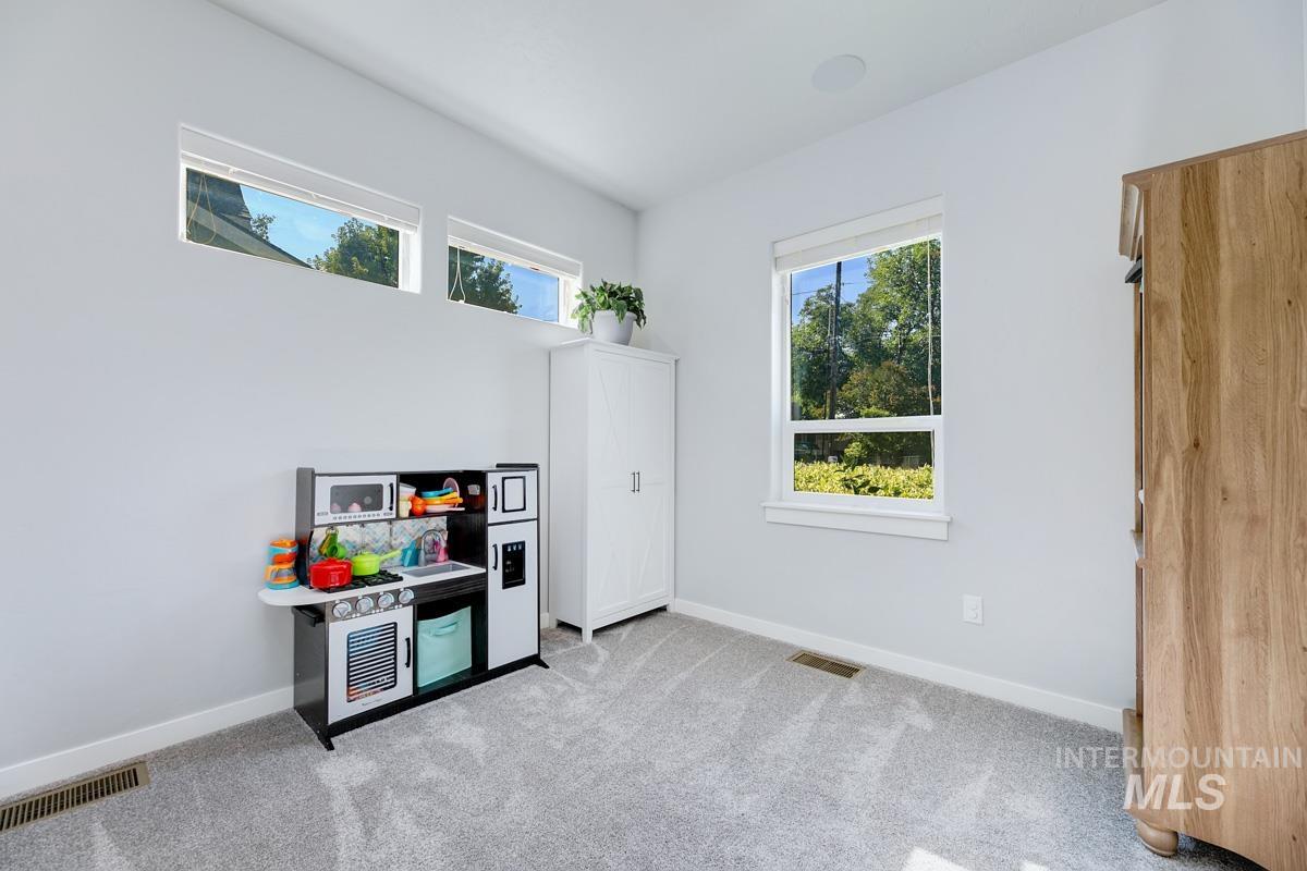 Game room with carpet and baseboards