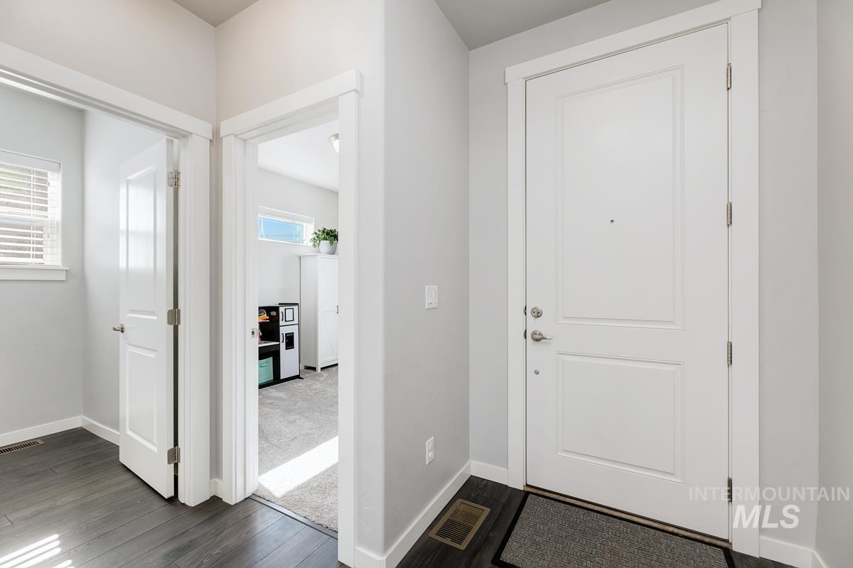 Foyer entrance featuring dark wood-style floors