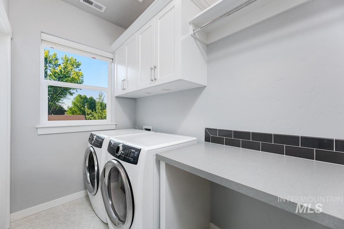Laundry area with cabinet space and washing machine and dryer