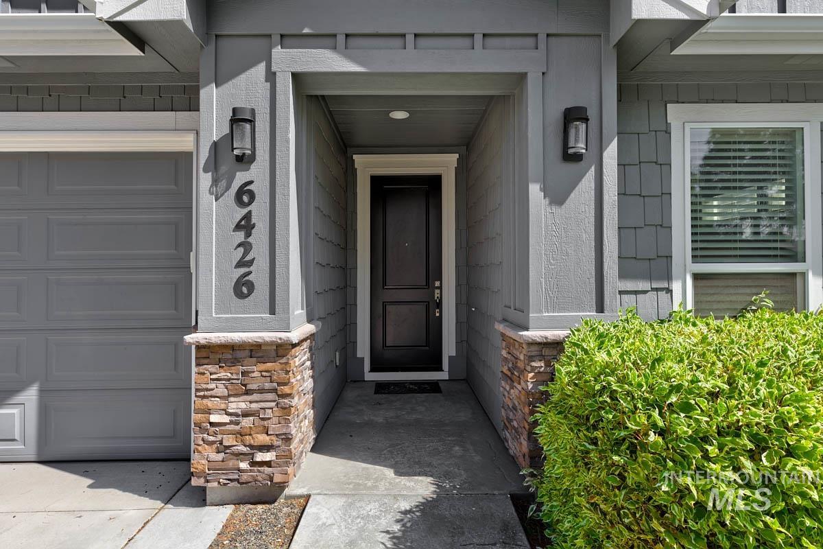 View of exterior entry with stone siding