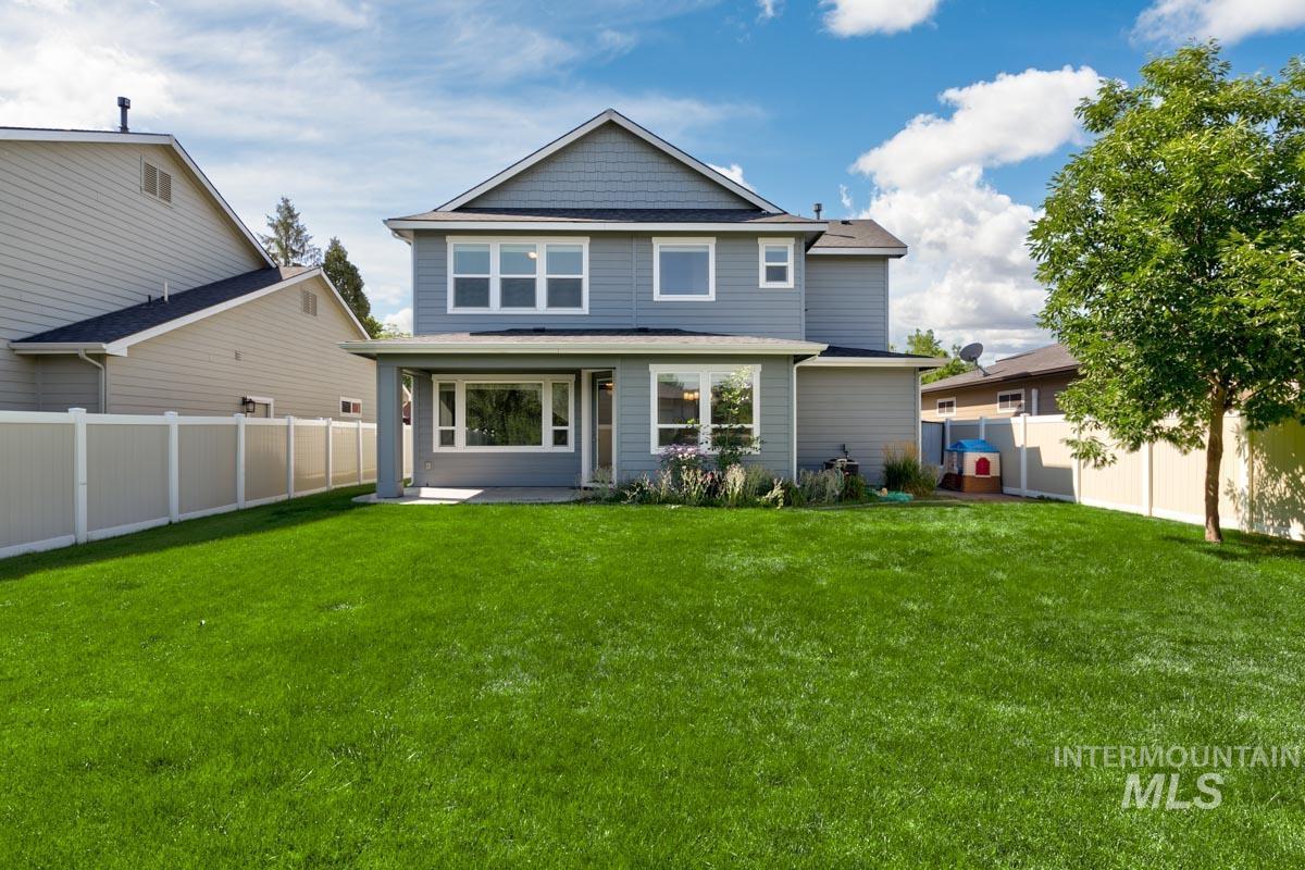 Rear view of property featuring a fenced backyard and a patio area