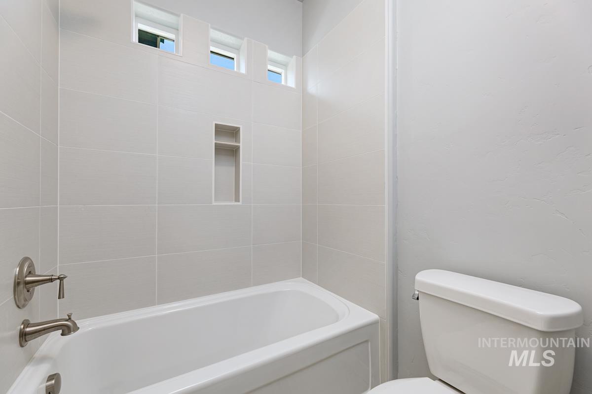 Full bath featuring shower / bath combination