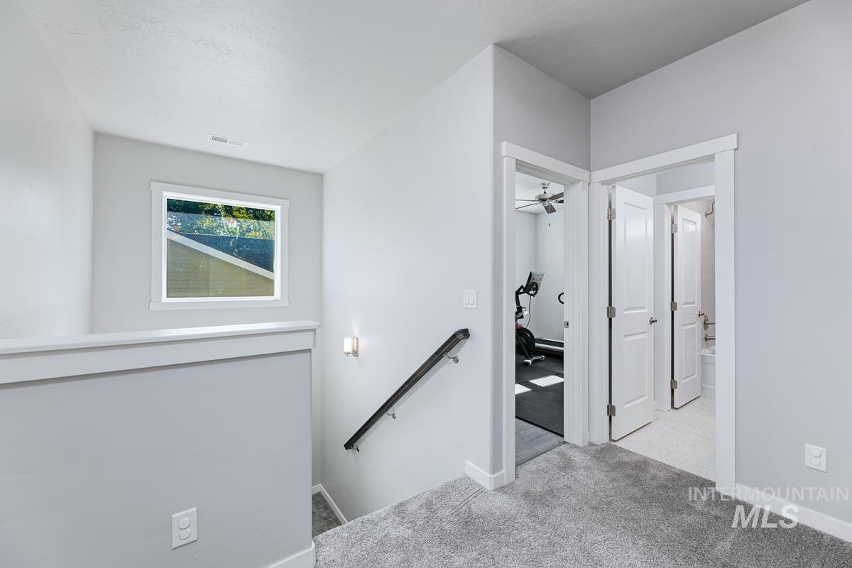 Stairs featuring carpet and baseboards