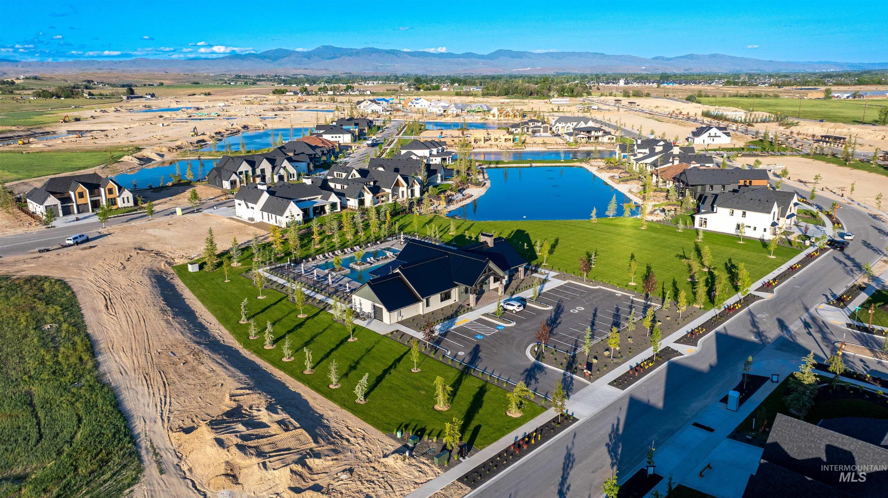 Aerial overview of property's location featuring a water and mountain view and nearby suburban area