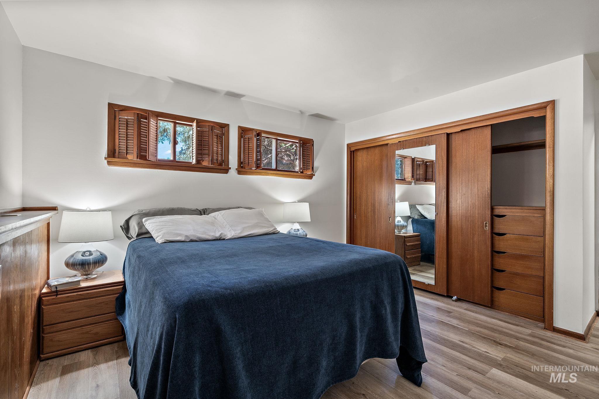 Bedroom with light wood-style floors and a closet