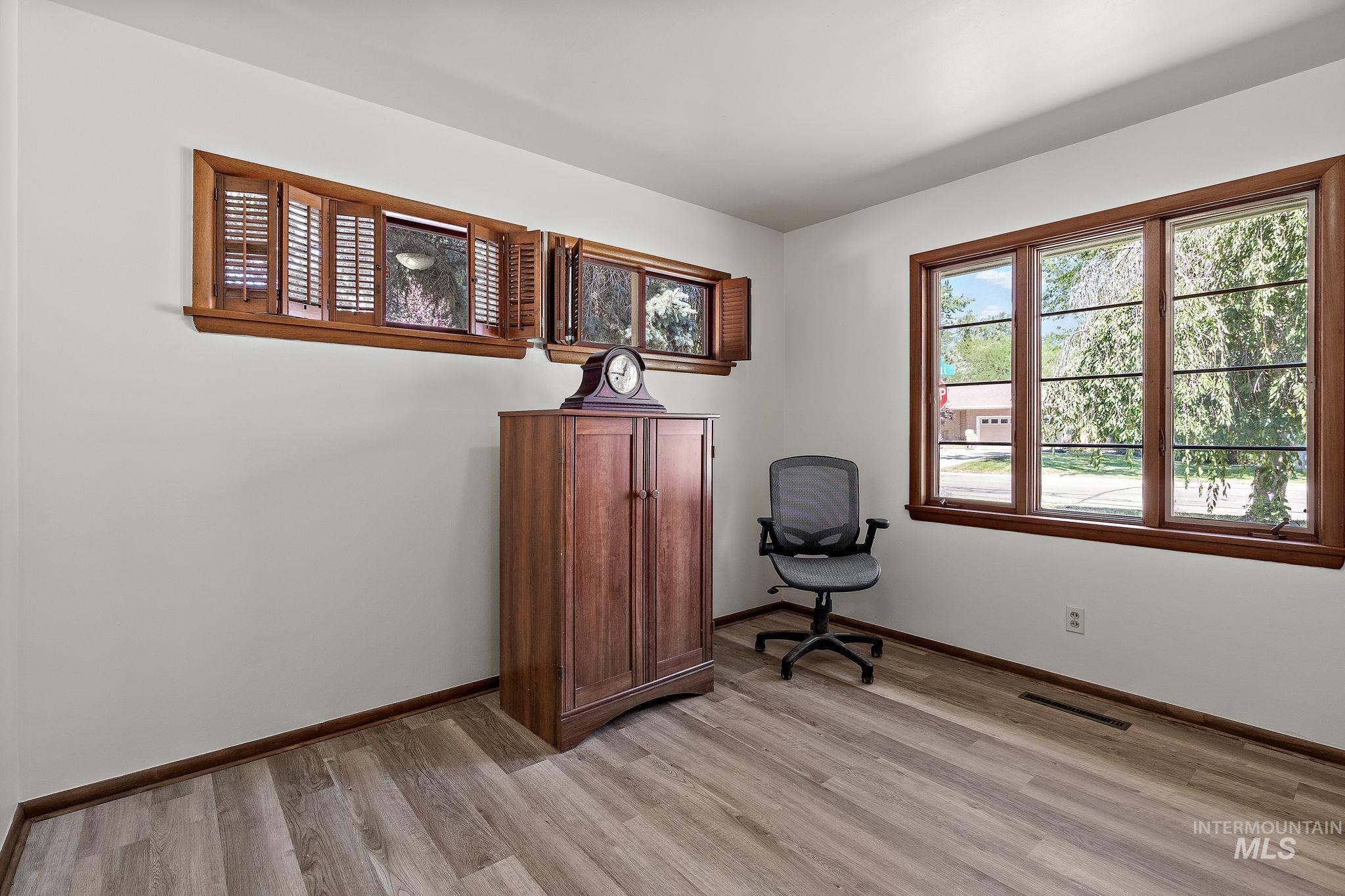 Sitting room featuring baseboards and light wood finished floors