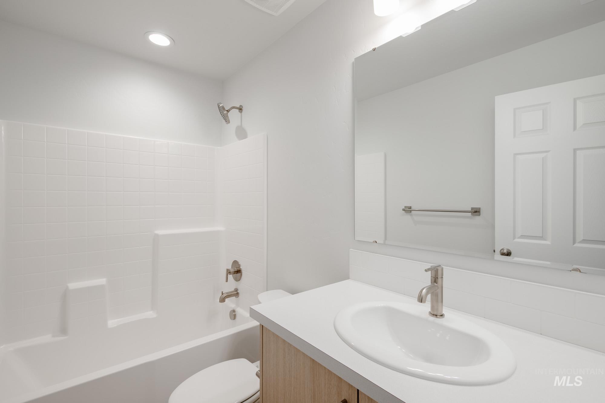Full bathroom featuring shower / bath combination and vanity