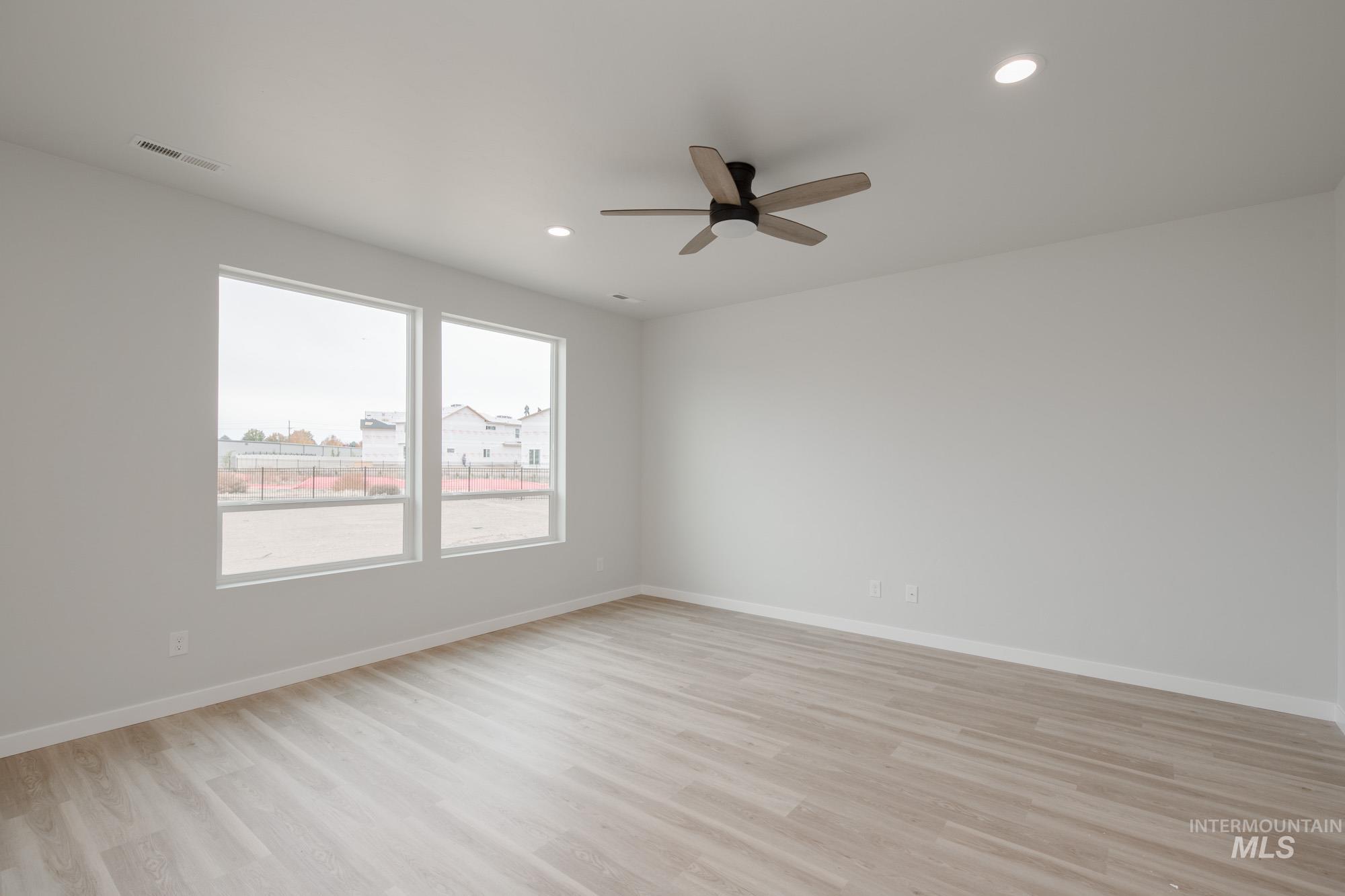 Spare room featuring light wood-style flooring, recessed lighting, and ceiling fan
