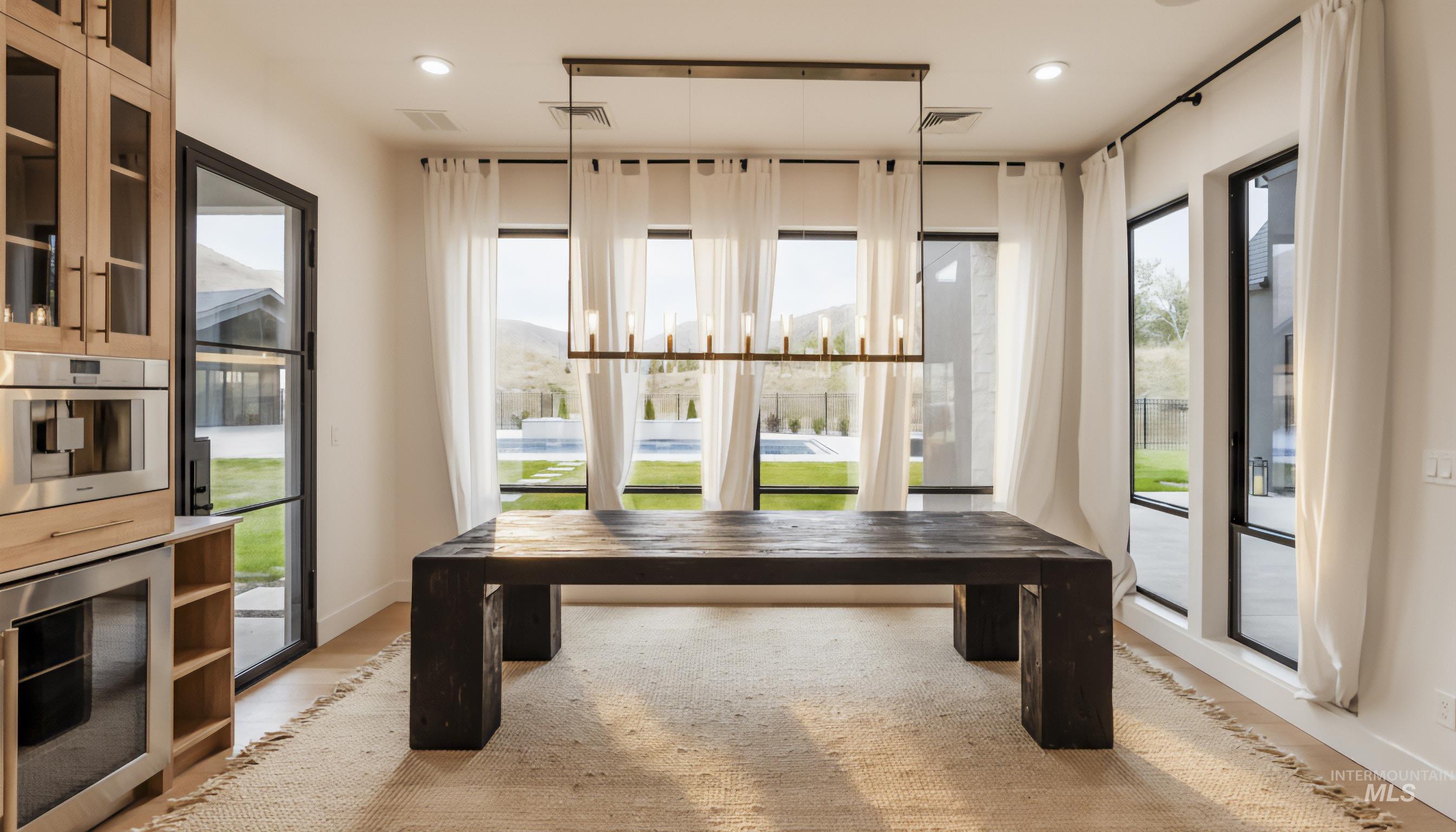 Dining room with healthy amount of natural light, recessed lighting, and light wood-style floors