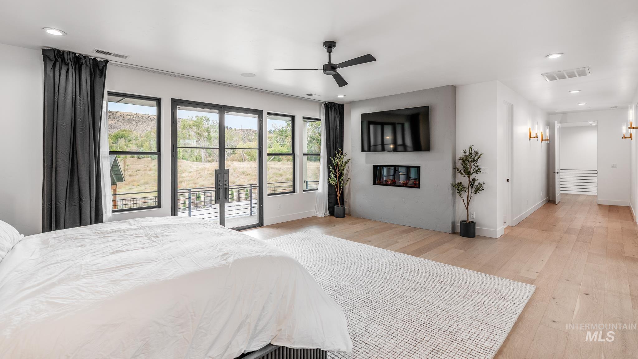 Bedroom with light wood-style floors, access to outside, a ceiling fan, and recessed lighting