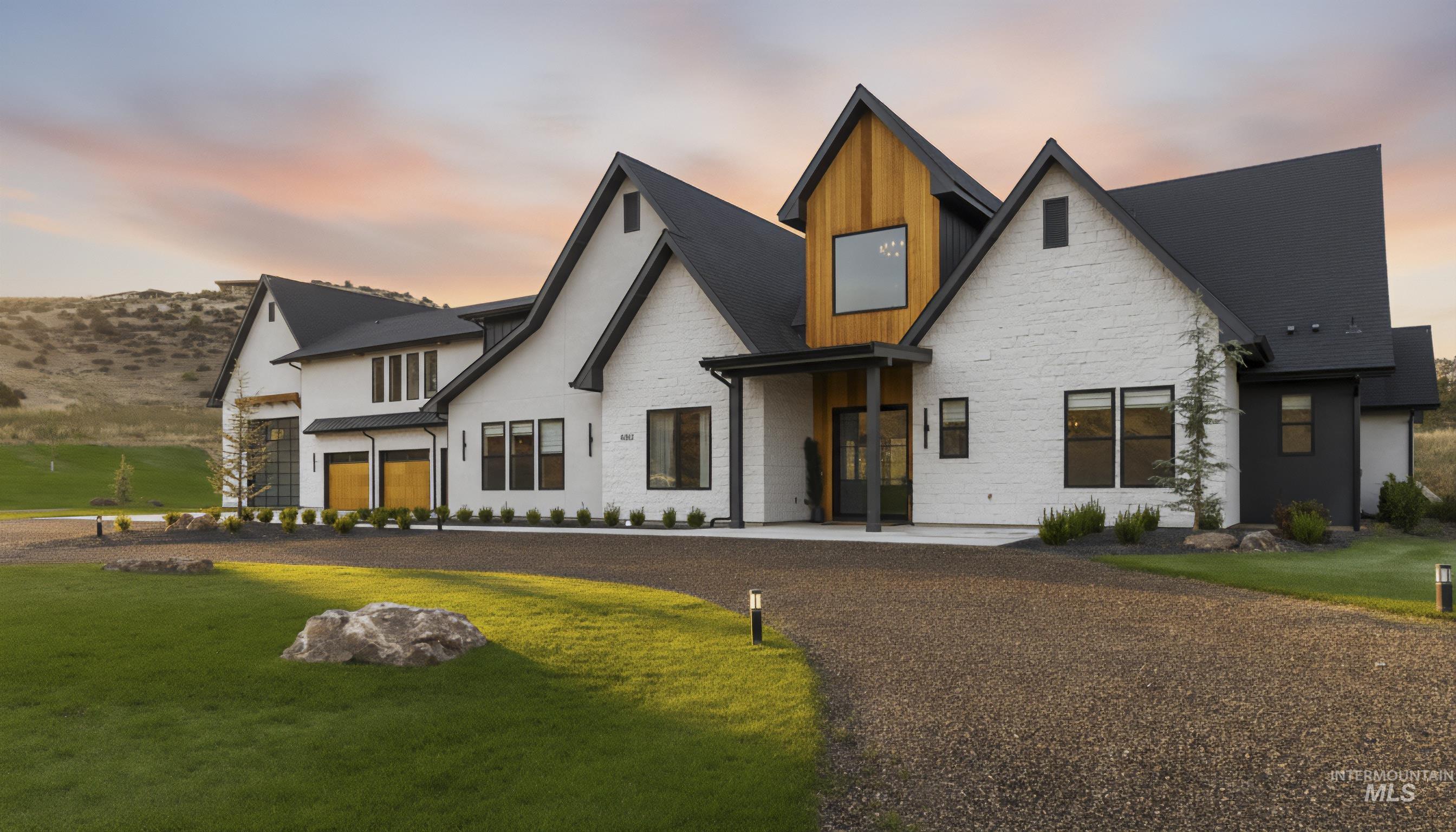 View of front facade with stone siding, board and batten siding, and a front lawn