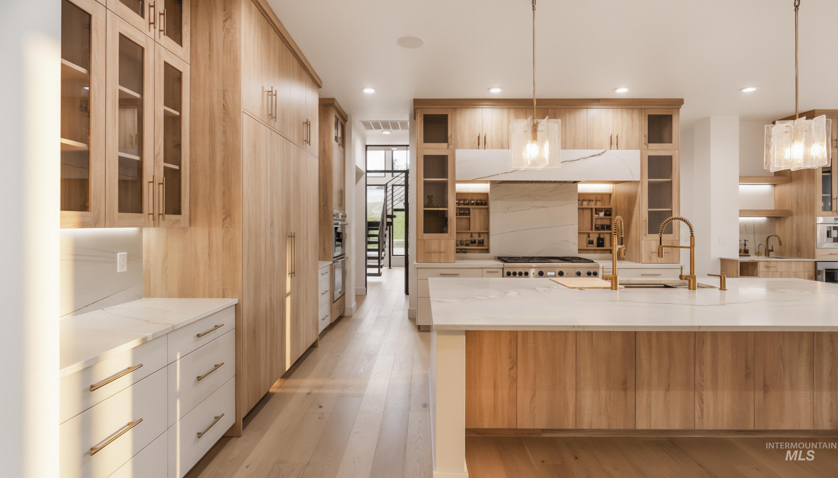 Kitchen with glass insert cabinets, light stone countertops, pendant lighting, modern cabinets, and recessed lighting