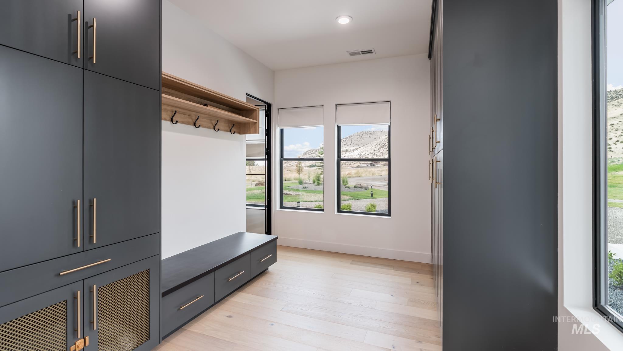 Mudroom featuring light wood-style flooring and recessed lighting