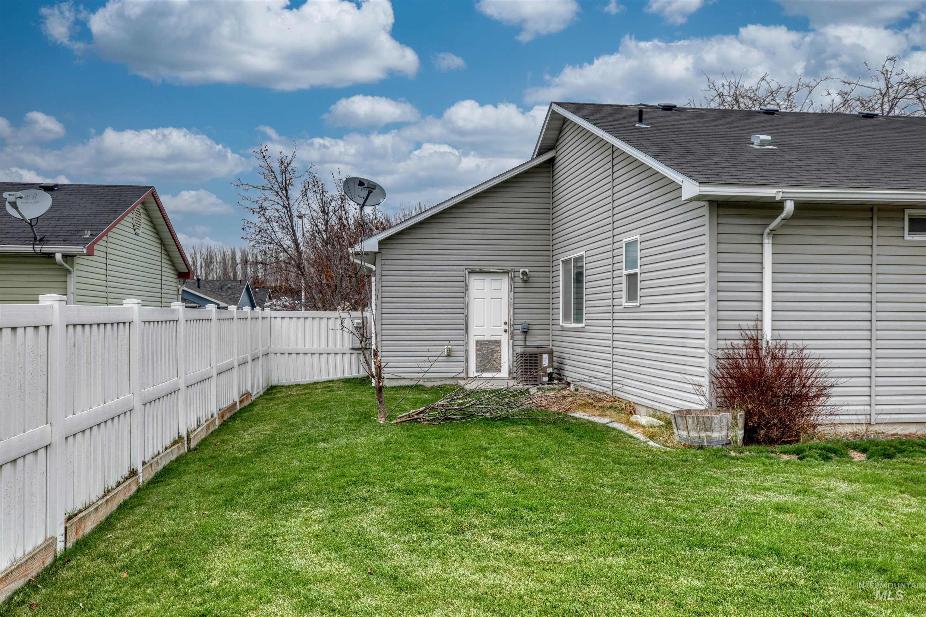 Rear view of property featuring a fenced backyard