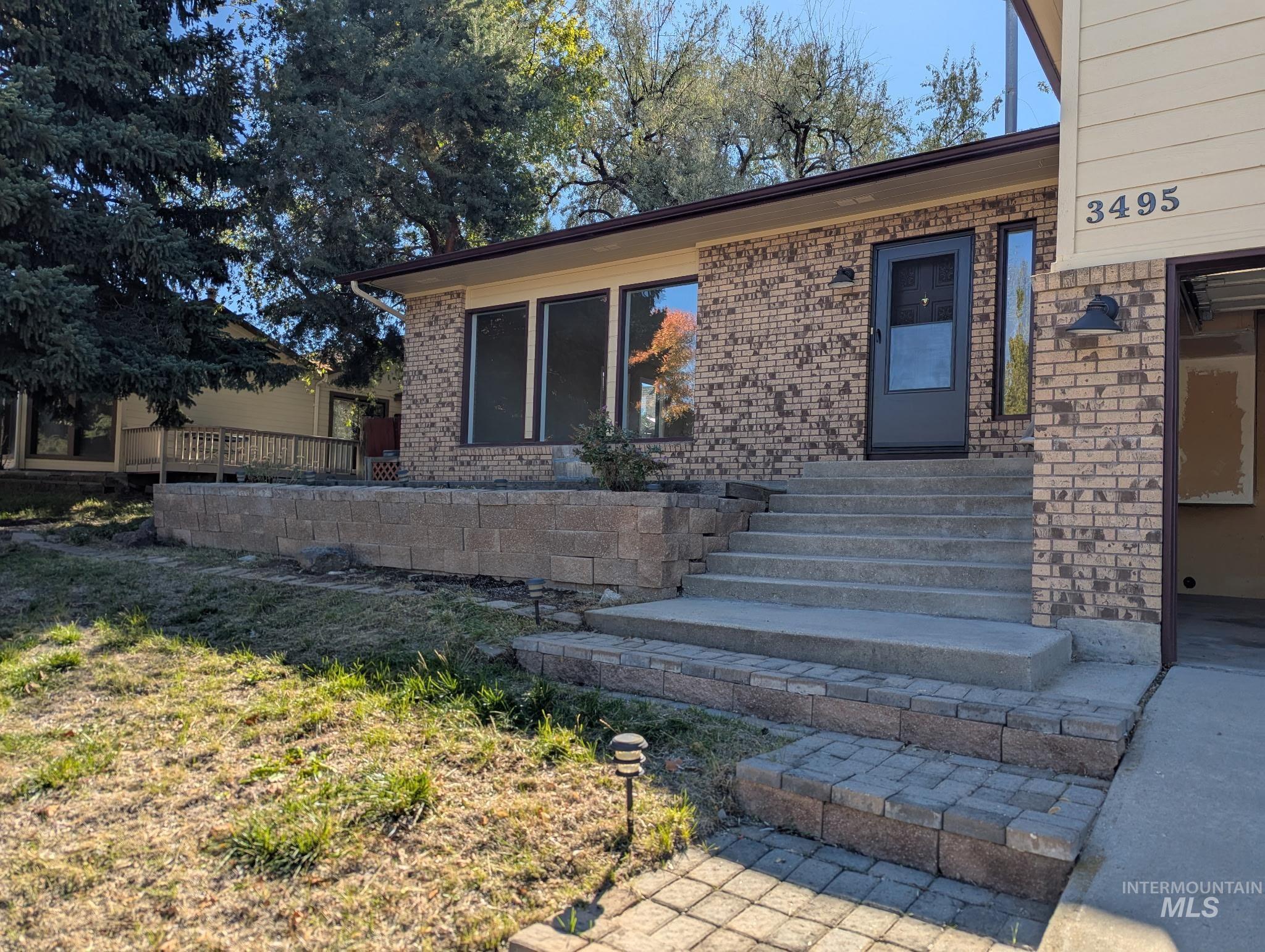 Doorway to property with brick siding