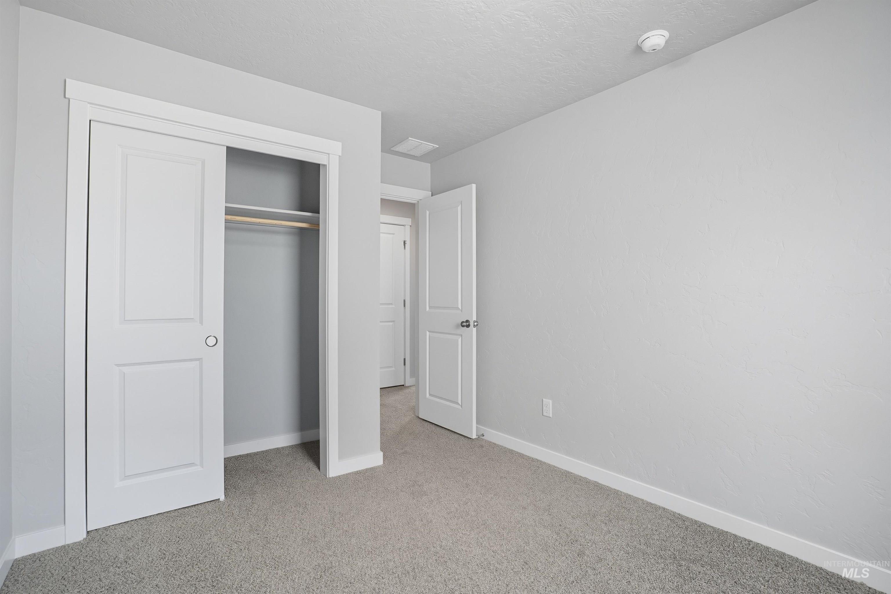 Neutral gray walls with white trim and gray carpeting
