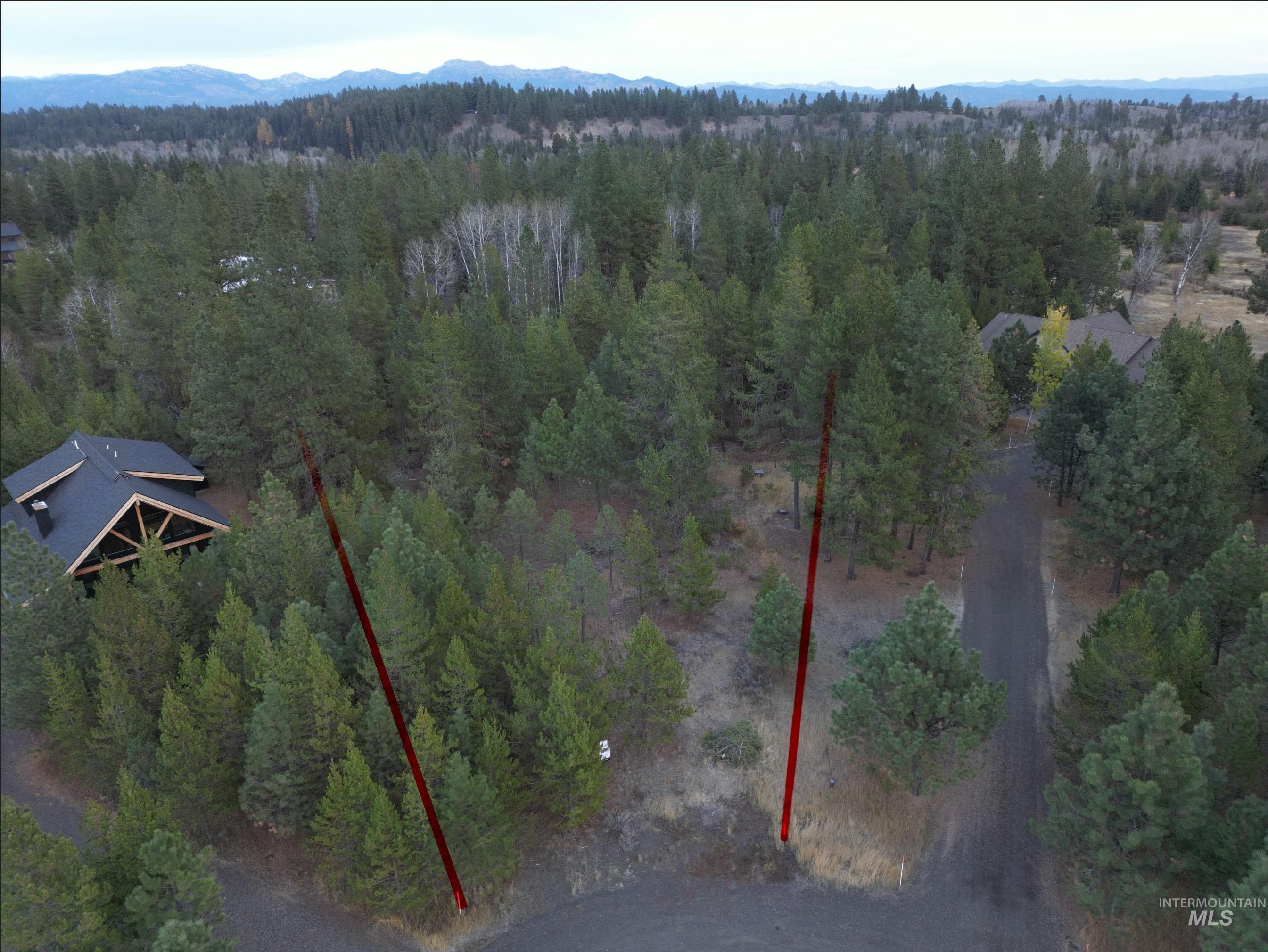 Aerial overview of property's location with property parcel outlined and mountains