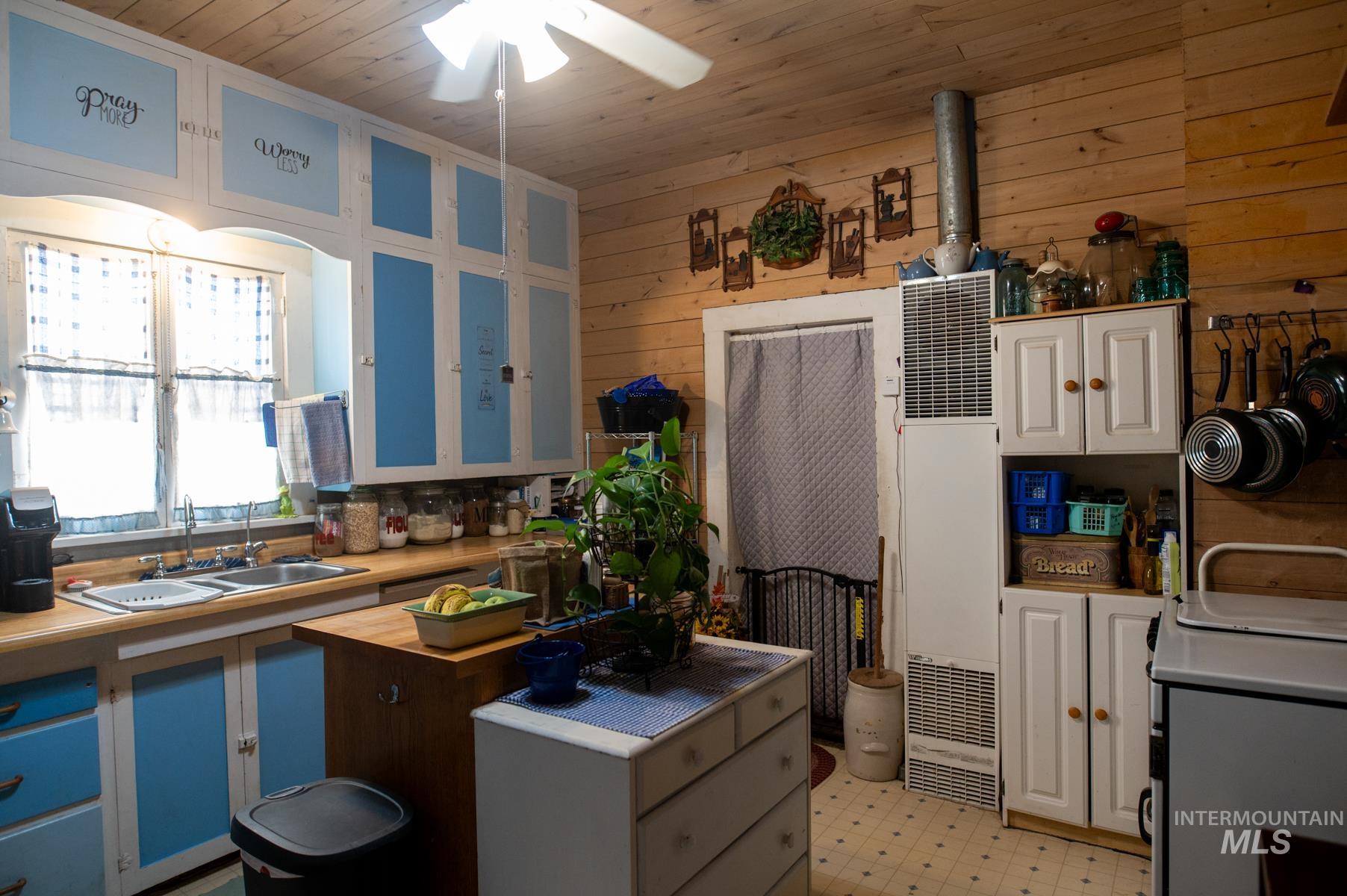 Kitchen featuring wood-finish wall paneling and a wood-finish ceiling