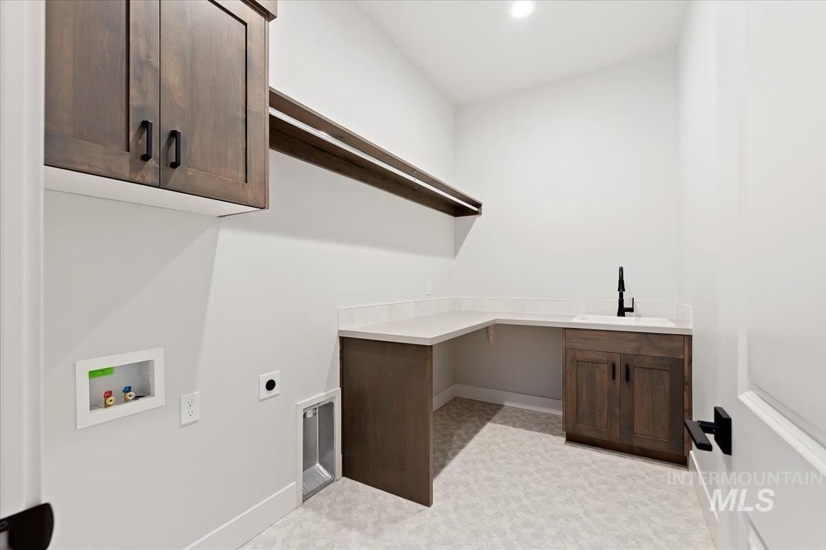 Washroom featuring hookup for an electric dryer, cabinet space, hookup for a washing machine, light flooring, and recessed lighting