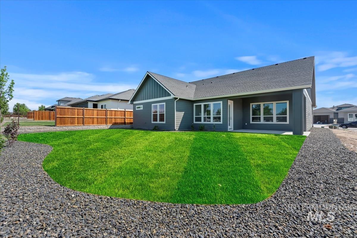 Rear view of property with roof with shingles, a patio, and board and batten siding