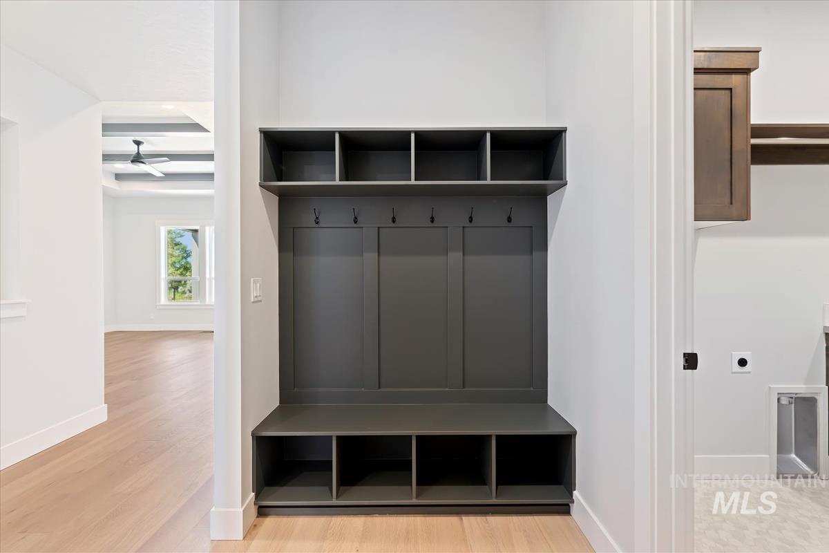 Mudroom featuring beam ceiling, light wood-style floors, and coffered ceiling