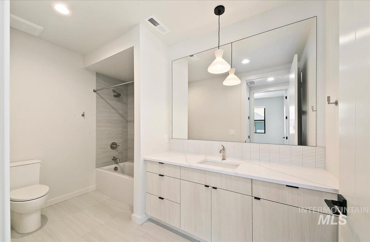 Full bath featuring shower / bath combination, recessed lighting, and vanity