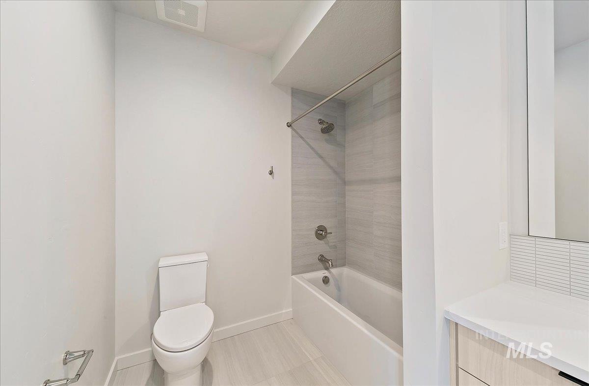 Full bathroom with shower / tub combination and light tile patterned floors
